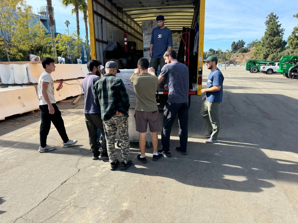 Moving crew working together at the back of a truck